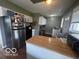 Well-lit kitchen featuring stainless steel appliances, neutral cabinets, and a cozy breakfast bar, ready for culinary adventures at 1820 Martin St, Indianapolis, IN 46237