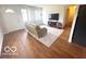 Relaxing living room with hard wood flooring, couch, and TV, perfect for unwinding at 1820 Martin St, Indianapolis, IN 46237