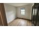 This empty bedroom features wood floors and a single window at 1836 Queensbridge Cir, Indianapolis, IN 46219