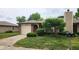 Charming single Gathering home with an attached garage and a beautifully landscaped front yard at 1836 Queensbridge Cir, Indianapolis, IN 46219