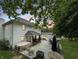 Spacious backyard with hot tub, outdoor seating, patio, grill, and lush greenery at 2015 Deer Lake Dr, Martinsville, IN 46151