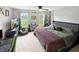 Bright bedroom with two windows, a keyboard, TV, large bed, beanbag chair, and a ceiling fan at 2015 Deer Lake Dr, Martinsville, IN 46151