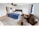 Well-lit bedroom features a queen-sized bed, loveseat, wood floors, and a view of the bathroom at 2015 Deer Lake Dr, Martinsville, IN 46151
