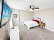 Cozy bedroom featuring gray carpet, ceiling fan, TV, and simple furnishings at 2015 Deer Lake Dr, Martinsville, IN 46151