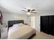 Comfortable bedroom with a queen bed, side table, and a wardrobe with a black curtain at 2015 Deer Lake Dr, Martinsville, IN 46151