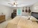Bedroom featuring a desk, guitars on the wall, and a comfortable bed with neutral tones at 2015 Deer Lake Dr, Martinsville, IN 46151