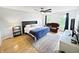 Bright bedroom with hardwood floors, queen-sized bed, TV, and a comfortable, reclining loveseat at 2015 Deer Lake Dr, Martinsville, IN 46151