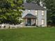 Inviting two-story brick home with a covered front porch and well-manicured lawn at 2015 Deer Lake Dr, Martinsville, IN 46151
