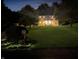 Exterior view of home at dusk, showcasing manicured lawn, illuminated walkway, and welcoming front porch at 2015 Deer Lake Dr, Martinsville, IN 46151