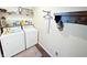 Well-organized laundry room with front load washer and dryer, featuring shelving, storage, and decor at 2015 Deer Lake Dr, Martinsville, IN 46151