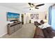 Cozy living room with neutral walls, brown sofa, and a large screen TV at 2015 Deer Lake Dr, Martinsville, IN 46151