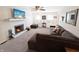 Bright living room featuring a brick fireplace, gray sectional, and natural light at 2015 Deer Lake Dr, Martinsville, IN 46151