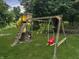 Backyard playground with slide, swings, and climbing structure surrounded by mature trees at 2015 Deer Lake Dr, Martinsville, IN 46151