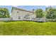 Spacious backyard with a large deck, lush green lawn, and mature trees at 2115 Napa Cir, Indianapolis, IN 46214