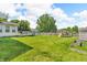Spacious backyard featuring a deck, wooden playset, storage shed, and lush green lawn at 2115 Napa Cir, Indianapolis, IN 46214