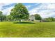 Expansive backyard with mature tree, large lawn, and fencing at 2115 Napa Cir, Indianapolis, IN 46214