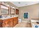 Bathroom features a double sink vanity, tiled floor, soaking tub and updated fixtures at 2115 Napa Cir, Indianapolis, IN 46214
