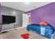 This bedroom features purple walls and unique decor at 2115 Napa Cir, Indianapolis, IN 46214