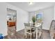 Bright dining room with modern table, white chairs, and view into the open-concept kitchen at 2115 Napa Cir, Indianapolis, IN 46214