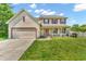 Charming two-story home with a well-maintained lawn, attached garage, and welcoming front porch at 2115 Napa Cir, Indianapolis, IN 46214