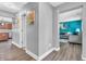 Hallway with wood floors and neutral-colored walls with a view into the kitchen and living room at 2115 Napa Cir, Indianapolis, IN 46214