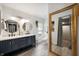 Stylish bathroom featuring double vanity, round mirrors, and a large framed mirror at 22 N Bolton Ave, Indianapolis, IN 46219
