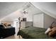 Cozy bedroom in attic with ceiling fan, sloped ceiling, and bed at 22 N Bolton Ave, Indianapolis, IN 46219