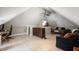Attic bonus room with wood floors, a sofa, a desk, and a bed, great for entertaining and relaxing at 22 N Bolton Ave, Indianapolis, IN 46219