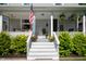 Inviting front porch with stairs, landscaping, patriotic decor, and a welcome sign at 22 N Bolton Ave, Indianapolis, IN 46219