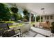 Cozy front porch featuring hanging ferns, a porch swing, and comfortable seating at 22 N Bolton Ave, Indianapolis, IN 46219