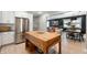 Open concept kitchen featuring a wood island and stainless steel refrigerator with an eat-in dining and living area at 22 N Bolton Ave, Indianapolis, IN 46219