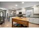 Bright kitchen with white cabinets, stainless steel appliances, and a wooden island at 22 N Bolton Ave, Indianapolis, IN 46219