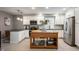 Modern kitchen with white cabinets, stainless steel appliances, and a wooden island at 22 N Bolton Ave, Indianapolis, IN 46219