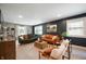 Bright living room with stylish sofas, hardwood floors, and large windows at 22 N Bolton Ave, Indianapolis, IN 46219