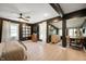Spacious main bedroom with dark accent walls, wood floors, and multiple windows for ample natural light at 22 N Bolton Ave, Indianapolis, IN 46219