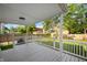 Back porch featuring a white railing, covered roof, and backyard views at 22 N Bolton Ave, Indianapolis, IN 46219