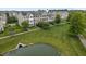 An aerial shot of townhomes surrounded by green space and a picturesque pond at 258 Coatsville Dr, Westfield, IN 46074
