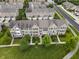 Aerial view of townhomes showcasing well-kept lawns and neighborhood street at 258 Coatsville Dr, Westfield, IN 46074