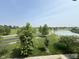 A beautiful aerial view of a community pond, trees, and walking path at 258 Coatsville Dr, Westfield, IN 46074