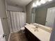 Well-lit bathroom featuring a single sink vanity and a polka-dot shower curtain over the bathtub at 258 Coatsville Dr, Westfield, IN 46074