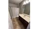 Well-lit bathroom featuring a single sink vanity and a shower-bathtub with a polka-dot curtain at 258 Coatsville Dr, Westfield, IN 46074