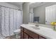 Well-lit bathroom featuring a shower with colorful polka dot shower curtain and a spacious vanity at 258 Coatsville Dr, Westfield, IN 46074