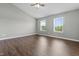 Spacious bedroom featuring hardwood floors, light-colored walls, vaulted ceilings, and abundant natural light from two windows at 258 Coatsville Dr, Westfield, IN 46074