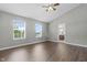 Bright bedroom featuring vaulted ceilings, hardwood floors, two windows, and an ensuite bathroom at 258 Coatsville Dr, Westfield, IN 46074