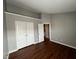 The bedroom features hardwood floors, white trim and bi-fold doors to the closet and entry to the room at 258 Coatsville Dr, Westfield, IN 46074