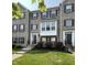 Attractive brick townhouse featuring black shutters, landscaped yard, and welcoming entrance at 258 Coatsville Dr, Westfield, IN 46074