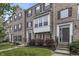 Brick townhome featuring large windows, dark shutters, and a well-manicured lawn at 258 Coatsville Dr, Westfield, IN 46074