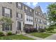 Charming brick townhome featuring classic architecture, dark shutters, and professionally landscaped front yard at 258 Coatsville Dr, Westfield, IN 46074