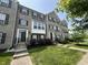 Charming brick townhouse featuring black shutters, a landscaped yard, and inviting entryway at 258 Coatsville Dr, Westfield, IN 46074