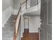 Inviting home foyer with staircase, wood floors, and neutral color palette at 258 Coatsville Dr, Westfield, IN 46074